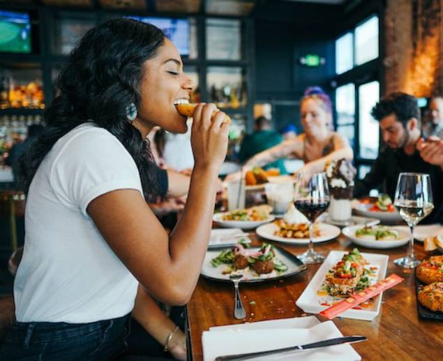 Young adults eating at restaurant